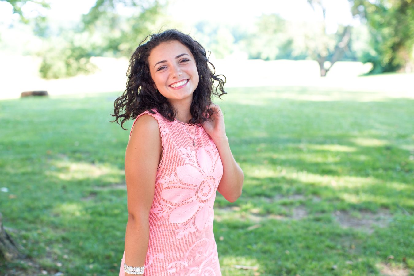A teenager smiling confidently while wearing Invisalign aligners.